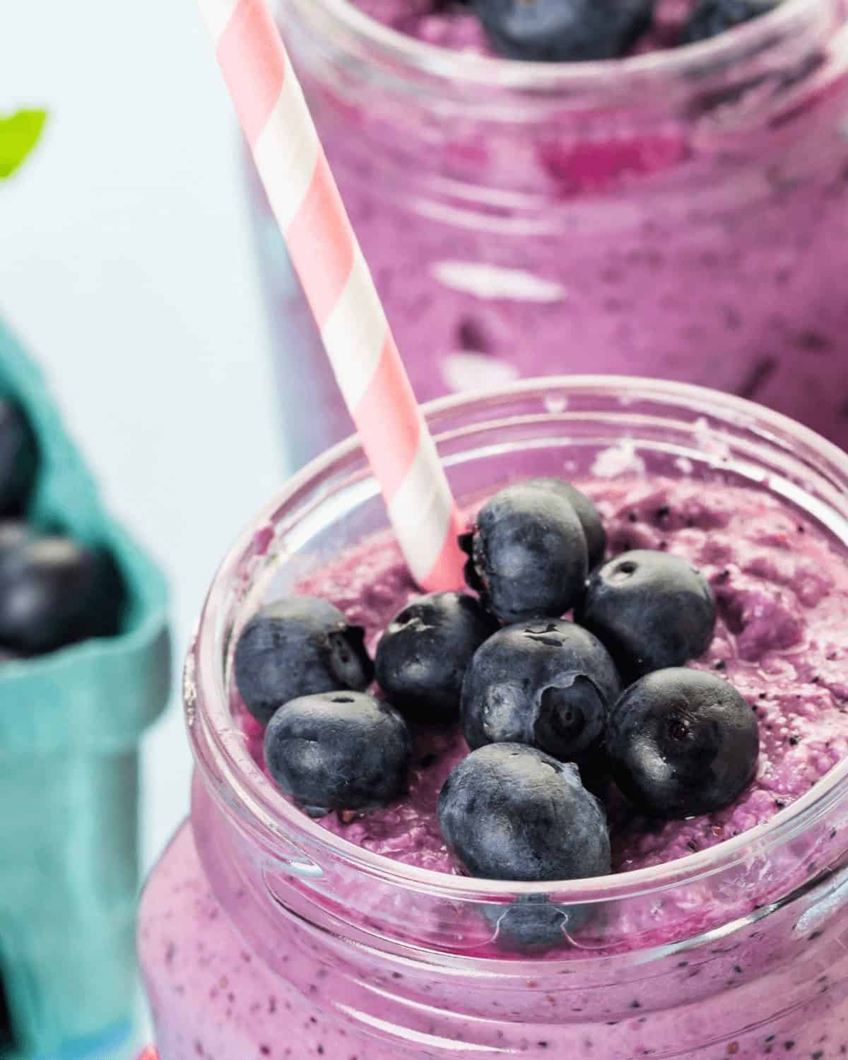 A refreshing frosty drink in a jar with a straw.