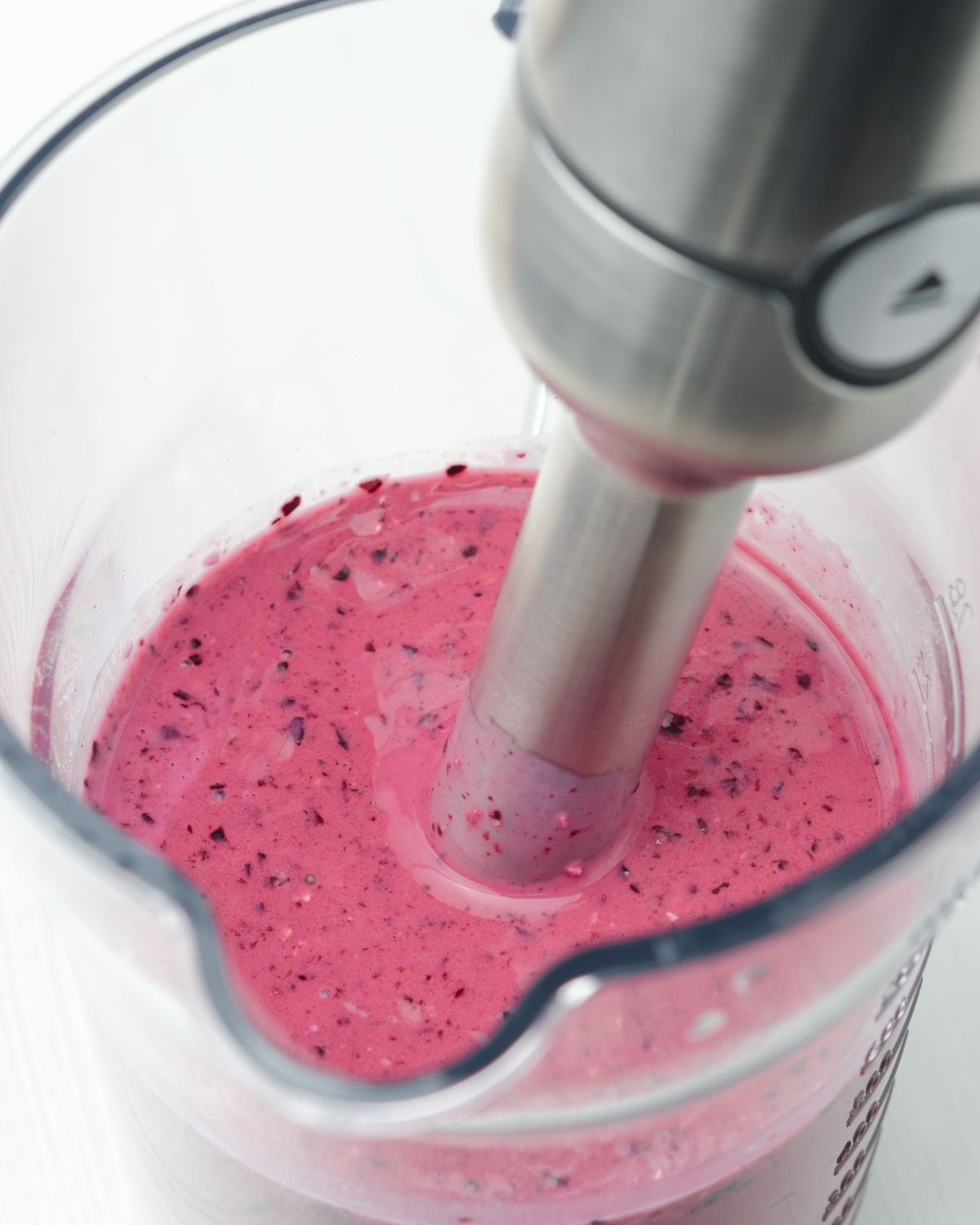 A blender mixing the fruit together.