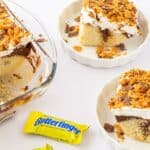 A pan of the finishes dessert with a mini candy bar on the side.