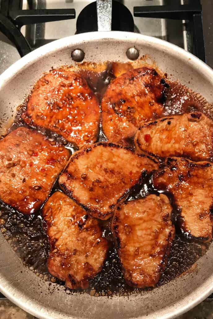 Korean Pork Chops cooking in a gray pan.