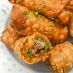 Taco Egg Rolls with meat and herbs on a plate.