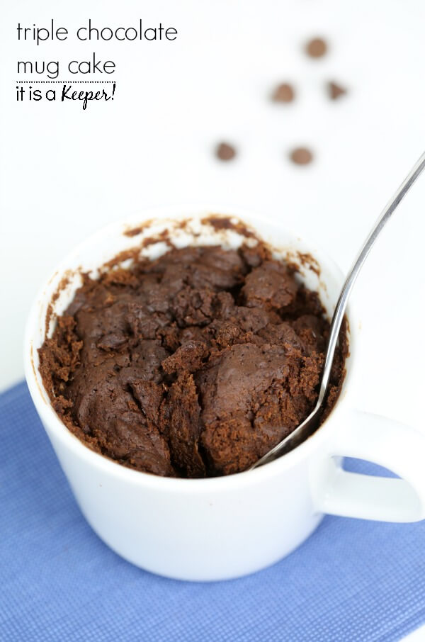 This Triple Chocolate Mug Cake in a white cup with a metal spoon