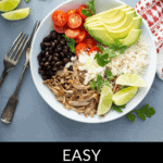 A bowl containing black beans, shredded chicken, rice, avocado slices, cherry tomatoes, lime wedges, and cilantro with utensils on the side. Text reads "Easy Chicken Burrito Bowl." This delightful chicken burrito bowl is perfect for a quick and tasty meal.