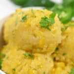 A bowl of creamy Mexican corn cake polenta garnished with fresh parsley.