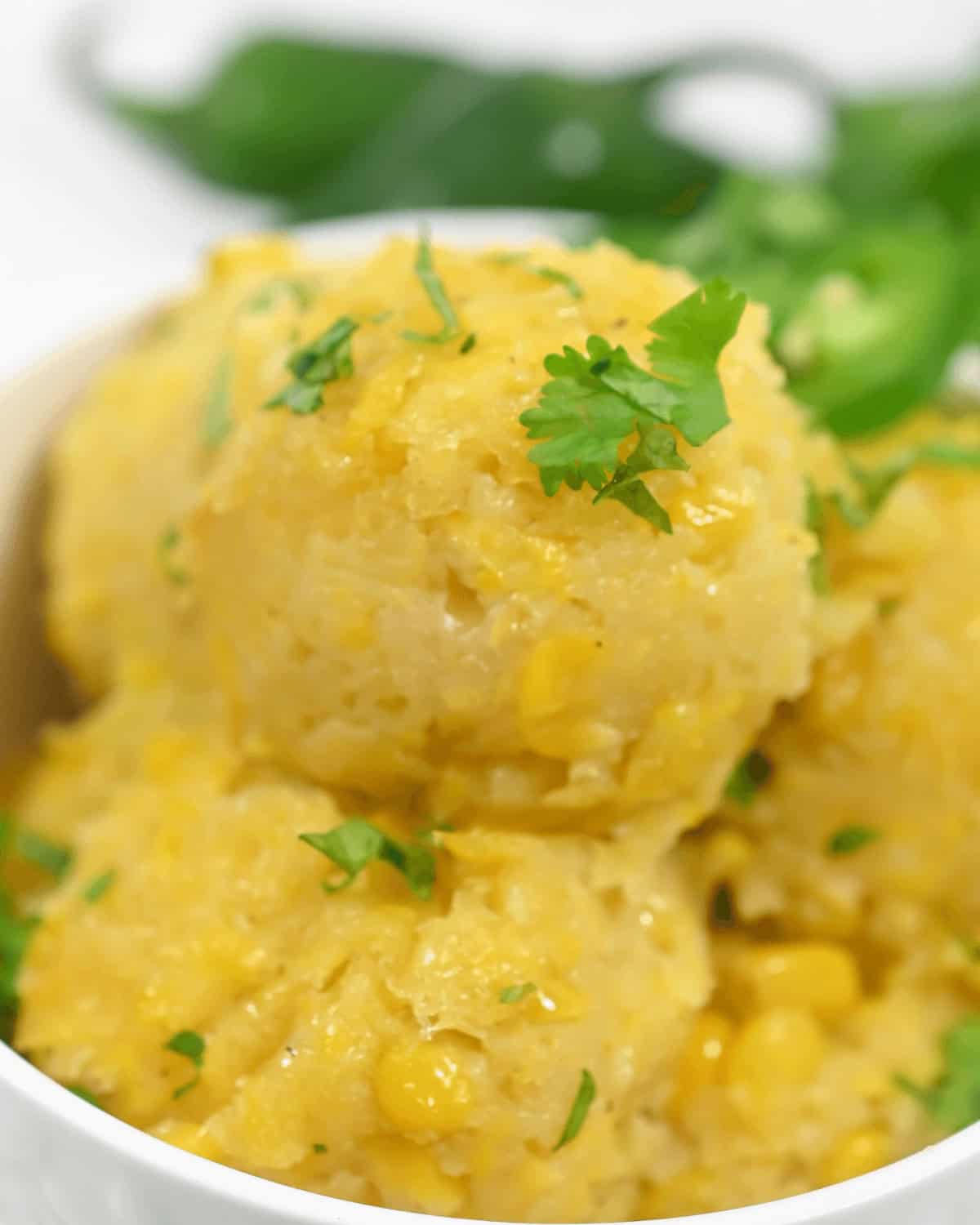 A bowl of creamy Mexican corn cake polenta garnished with fresh parsley.