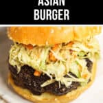 A close-up of an Asian Burger with a beef patty, sesame seed bun, and coleslaw topping, perfectly advertised as a game day meal.