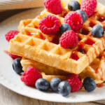 A bisquick waffle with berries on top.