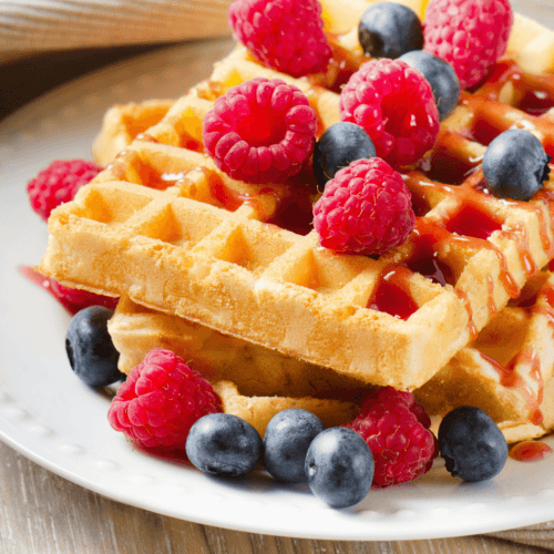 A bisquick waffle with berries on top.