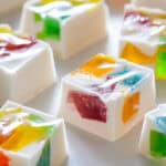 Mosaic-inspired gummy jello squares on a white surface.