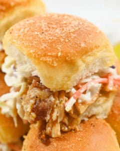 A closeup on a juicy bbq chicken slider.