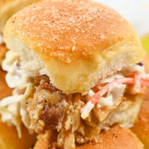 A closeup on a juicy bbq chicken slider.