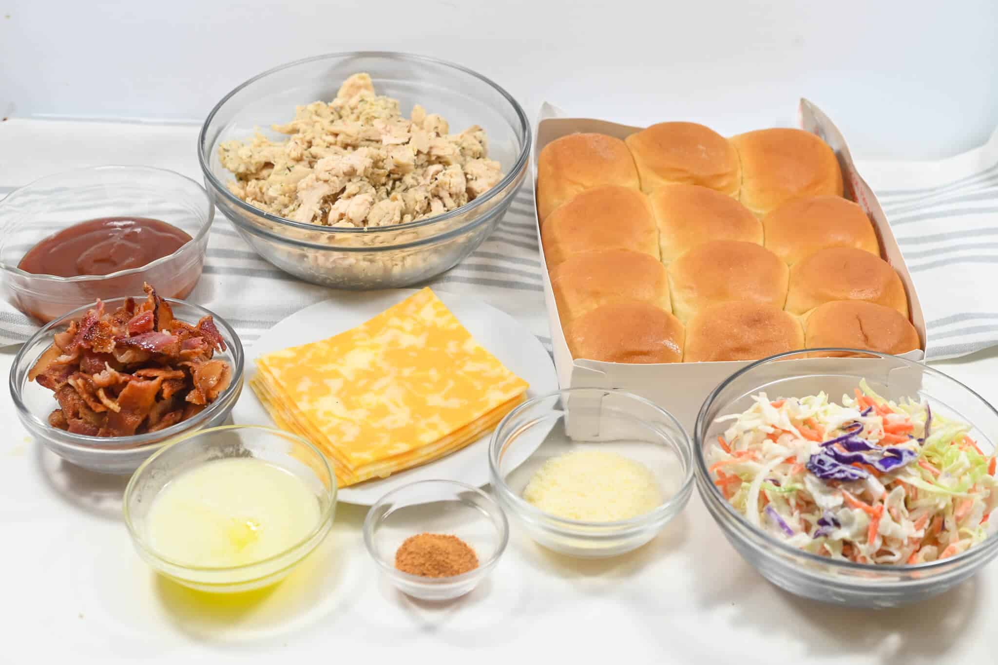 Rolls, chicken, cheese, coleslaw and sauce.