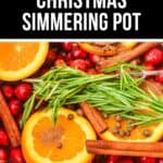 Slices of orange, cranberries, cinnamon sticks, rosemary, and spices arranged in a pot create the perfect Christmas Simmering Pot for a festive holiday aroma.