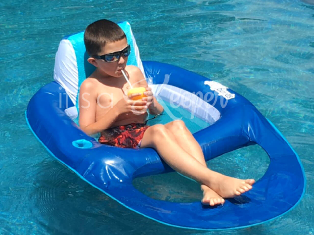 Child drinking Easy Frozen Slushies in a pool on a float. 