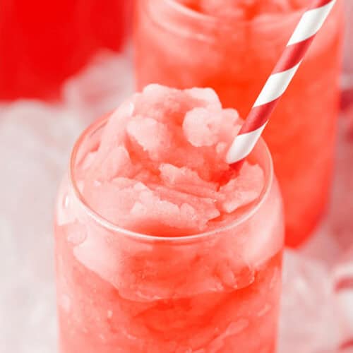 A colorful glass of kool-aid slushie.