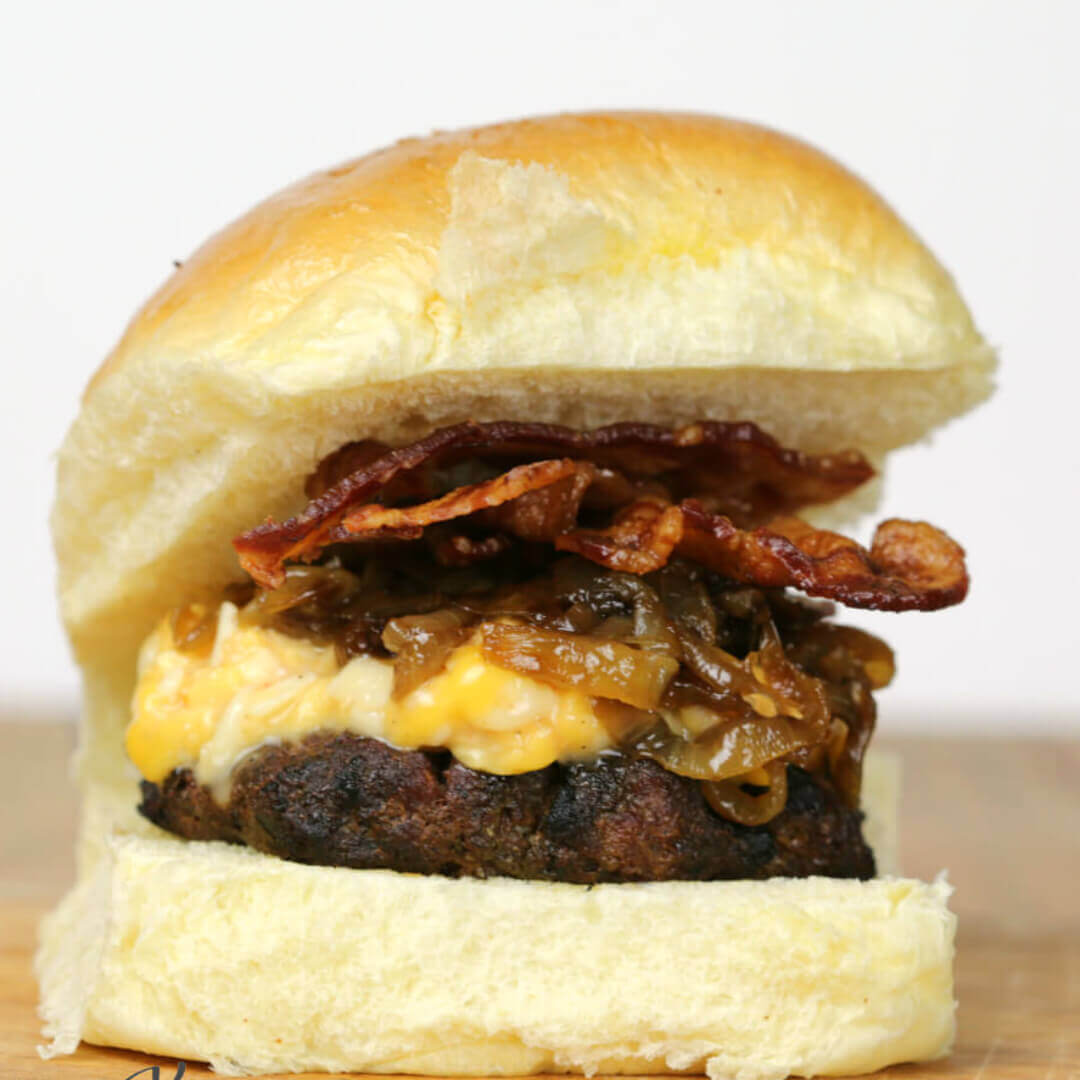 Lager Bacon Burger - this grilled burger recipe, topped with beer cheese and caramelized onions will have you begging for more 