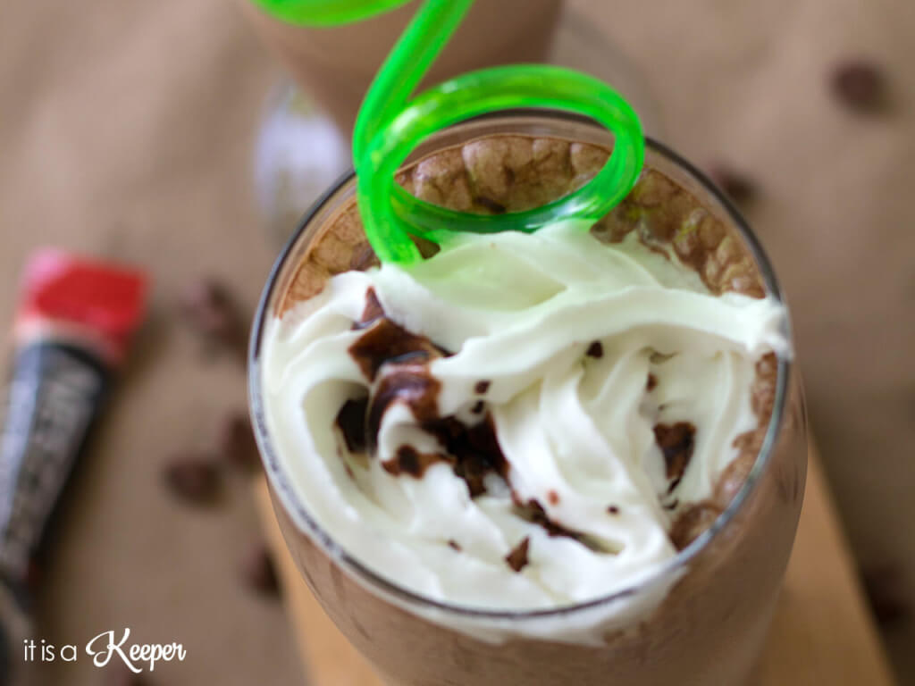 Mocha Milkshake in a glass cup with whipped cream and curly straw