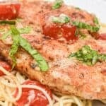 Chicken margherita over spaghetti.