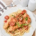 A white plate topped with easy chicken margerita.