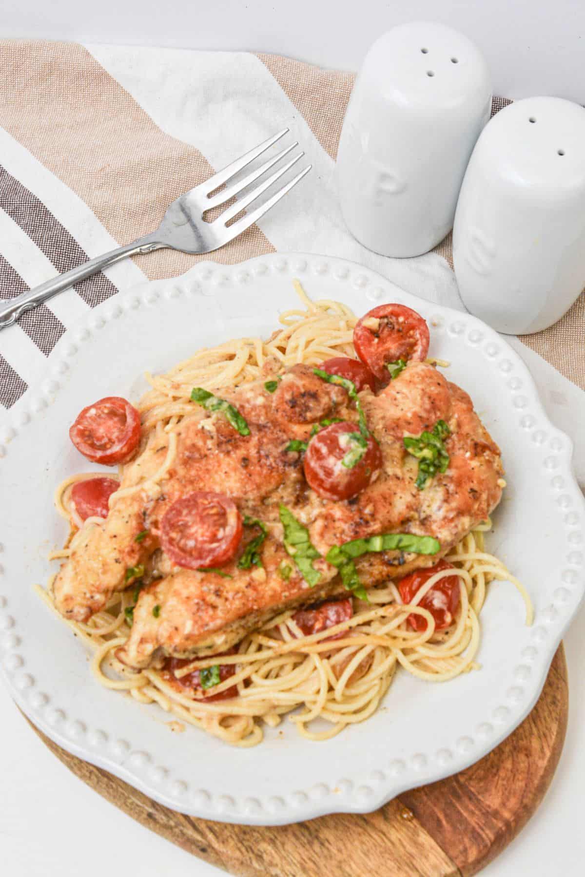 A white plate topped with easy chicken margerita.