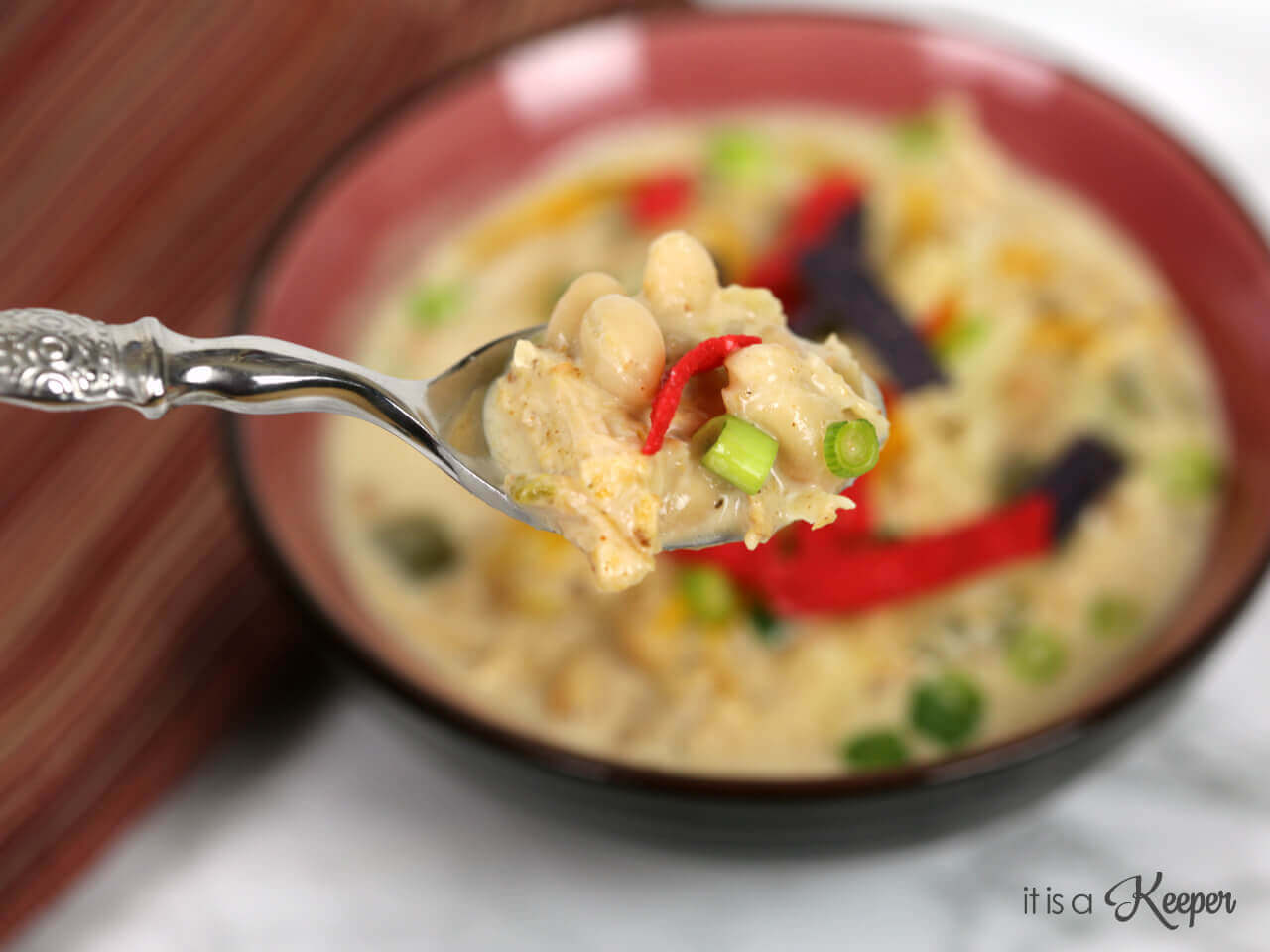 Slow Cooker White Chicken Chili on a metal spoon. 