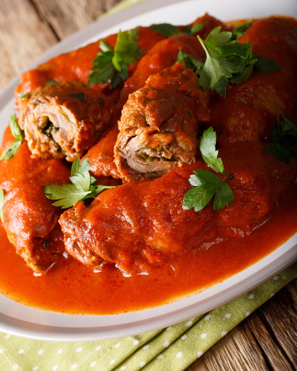 An Italian plate of Braciole, a delicious dish consisting of meat and sauce.
