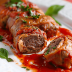An Italian Braciole, a plate of meat wrapped in a luscious tomato sauce.
