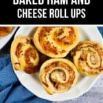 A plate with four delicious Ham and Cheese Roll Ups, perfectly baked and displayed on a white dish with a blue cloth underneath.