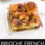 A slice of Brioche French Toast Casserole rests on a square plate, with the remaining golden casserole visible in the baking dish behind it.