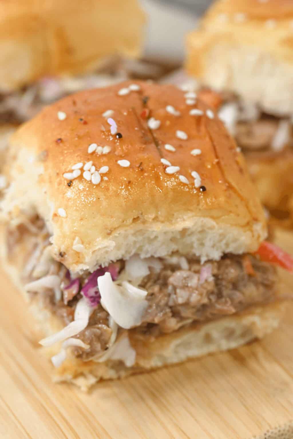 A closeup of shredded pork sliders.