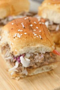 A closeup of shredded pork sliders.
