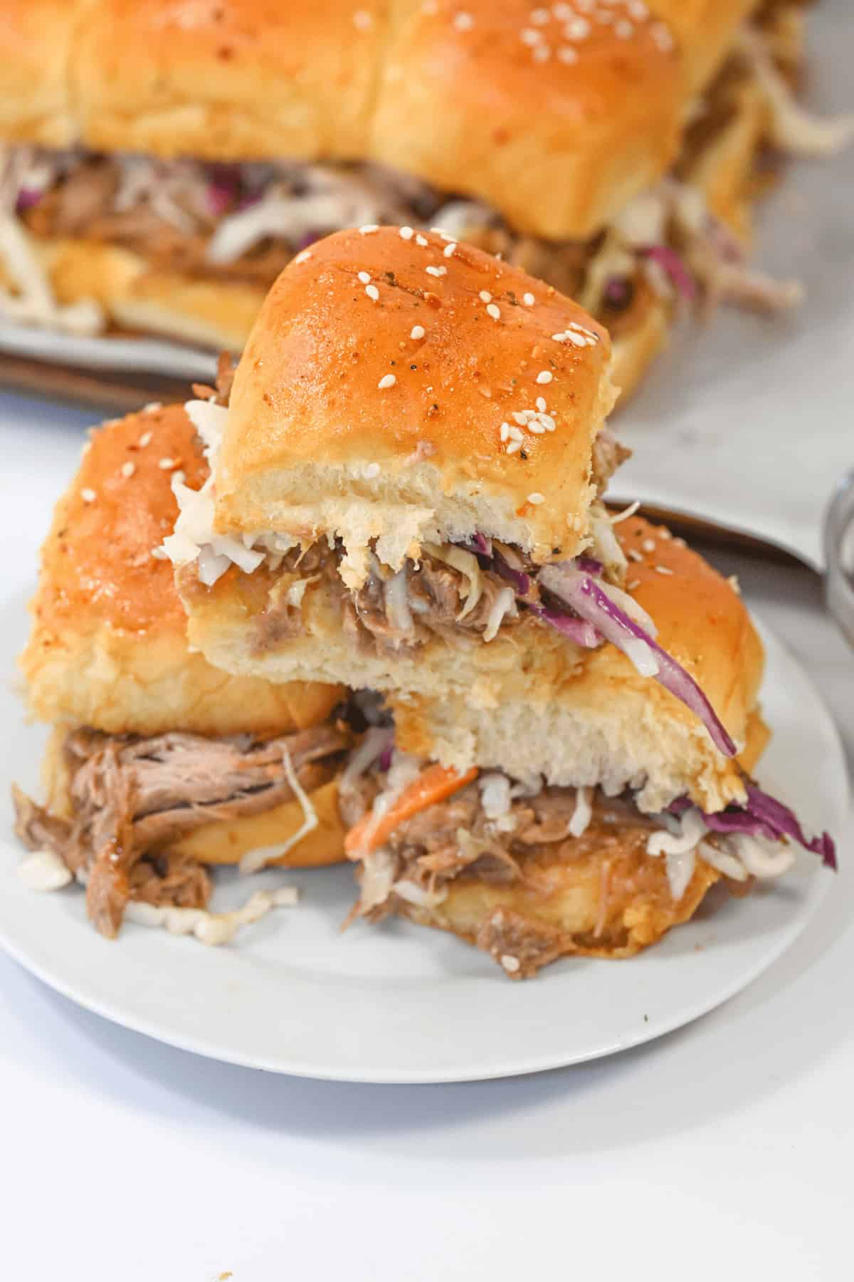 A stack of shredded pork sliders.