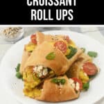 Plate of breakfast croissant roll ups filled with scrambled eggs, topped with cherry tomatoes and garnished with green onions, presented with text labels "Breakfast" and "Croissant Roll Ups.