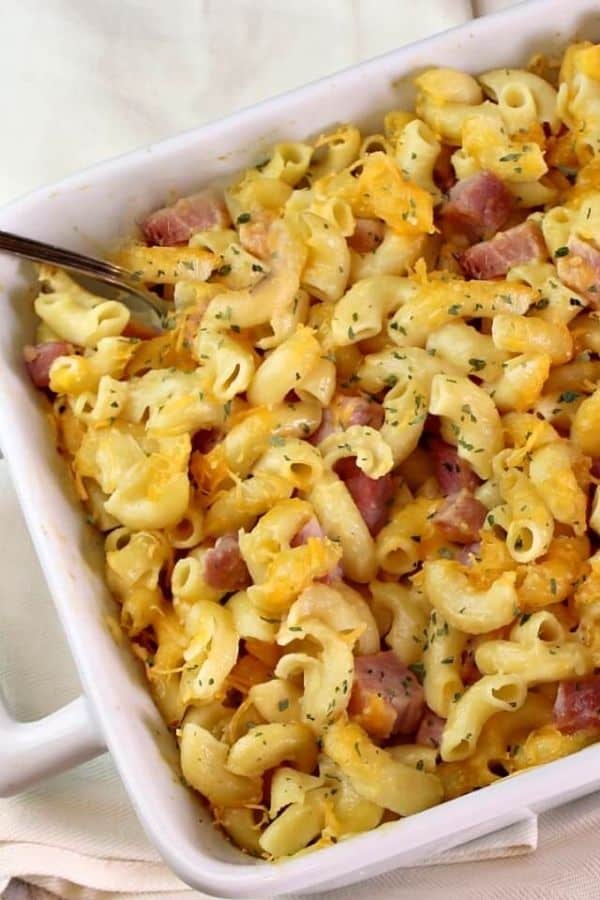 Close up of a white pan of macaroni and cheese with ham