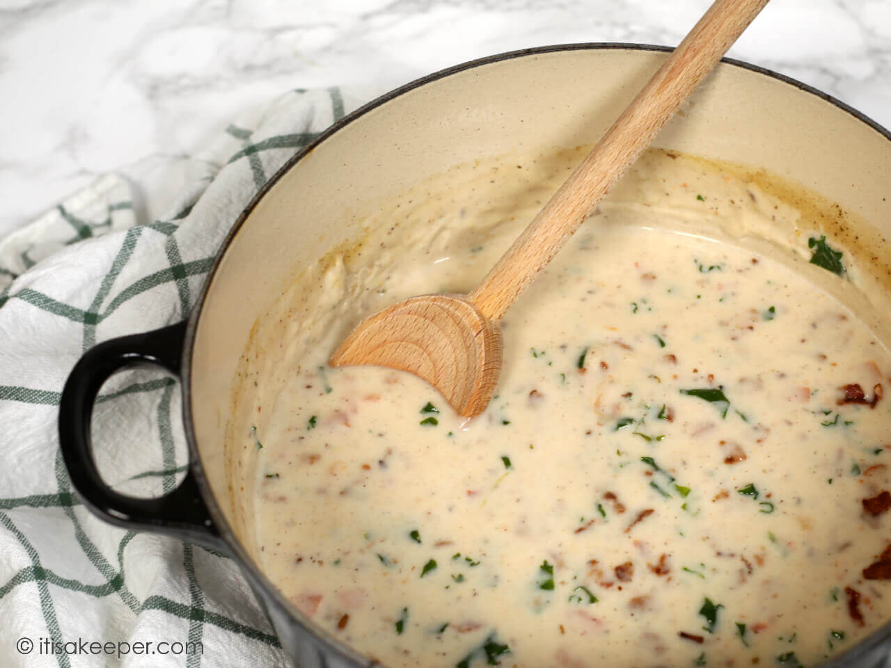 Creamy BLT Soup Recipe in a pot, with a wooden spoon.