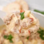 A cheesy potato soup with a spoonful of hamburger.