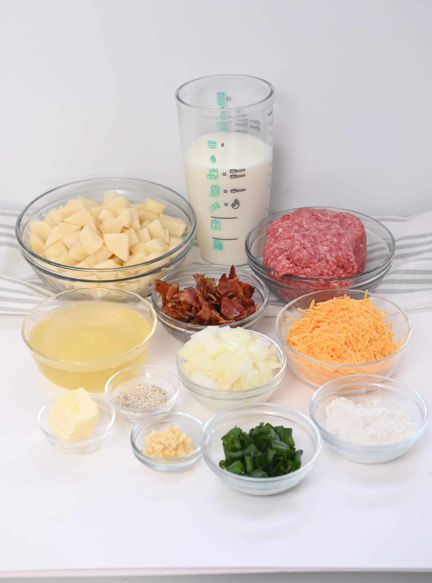 The ingredients for a hamburger, vegetables and cheese.