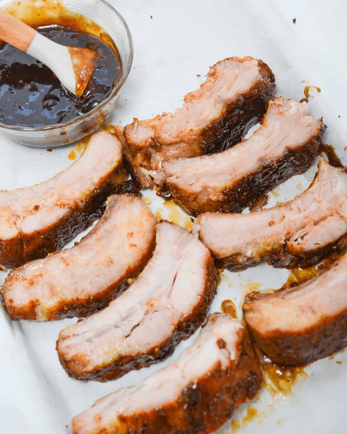 Slow Cooker BBQ Pork Ribs on a Baking Sheet with Sauce.