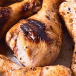 The marinade for grilled chicken drumsticks on a tray.