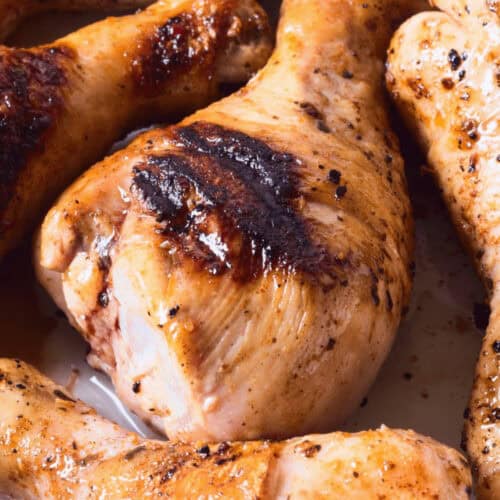 The marinade for grilled chicken drumsticks on a tray.