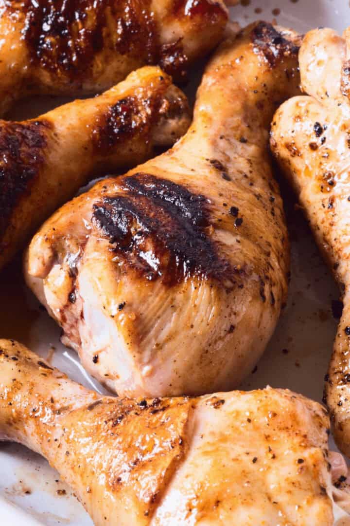 The marinade for grilled chicken drumsticks on a tray.