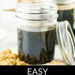 Jars of homemade honey teriyaki sauce with a label on a light background, encircled by ingredients.