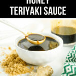 A bowl of honey teriyaki sauce with a spoon drizzling the sauce, surrounded by ginger and brown sugar, labeled as "easy honey teriyaki sauce.