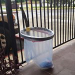 A small and clear canopy trash holder that is tied to the fence to save space for more party fun.