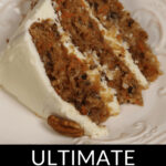A slice of carrot cake with pineapple and coconut topped with cream cheese frosting, garnished with a pecan.