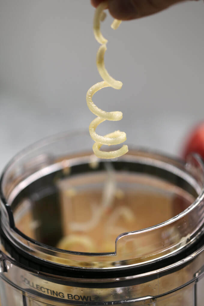 spiraled apple coming out of a Ninja blender cup 