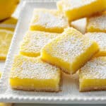 Delicious 2 Ingredient Lemon bars on a white plate.