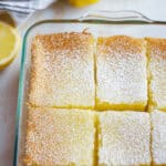 A glass dish of the dessert dusted with powdered sugar.
