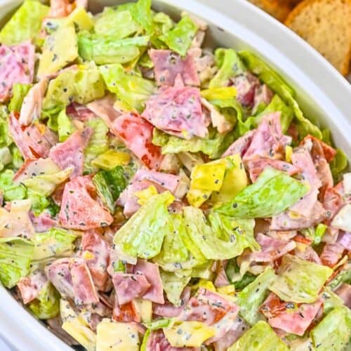 Italian Hoagie Dip in a white bowl with bread slices.