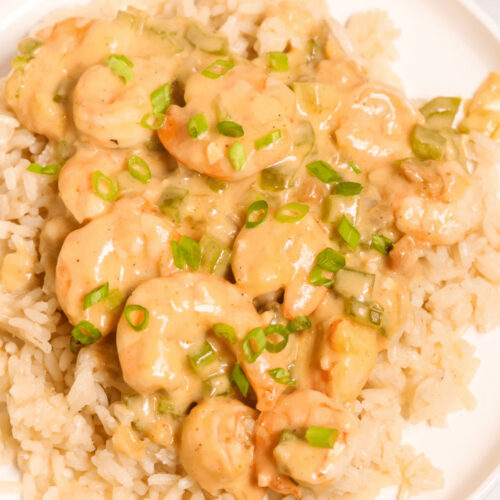 Creamy Garlic Shrimp and sauce over a bed of rice garnished with sliced green onions.